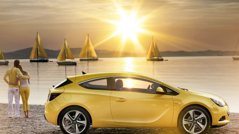 Yellow car at sunset by the sea