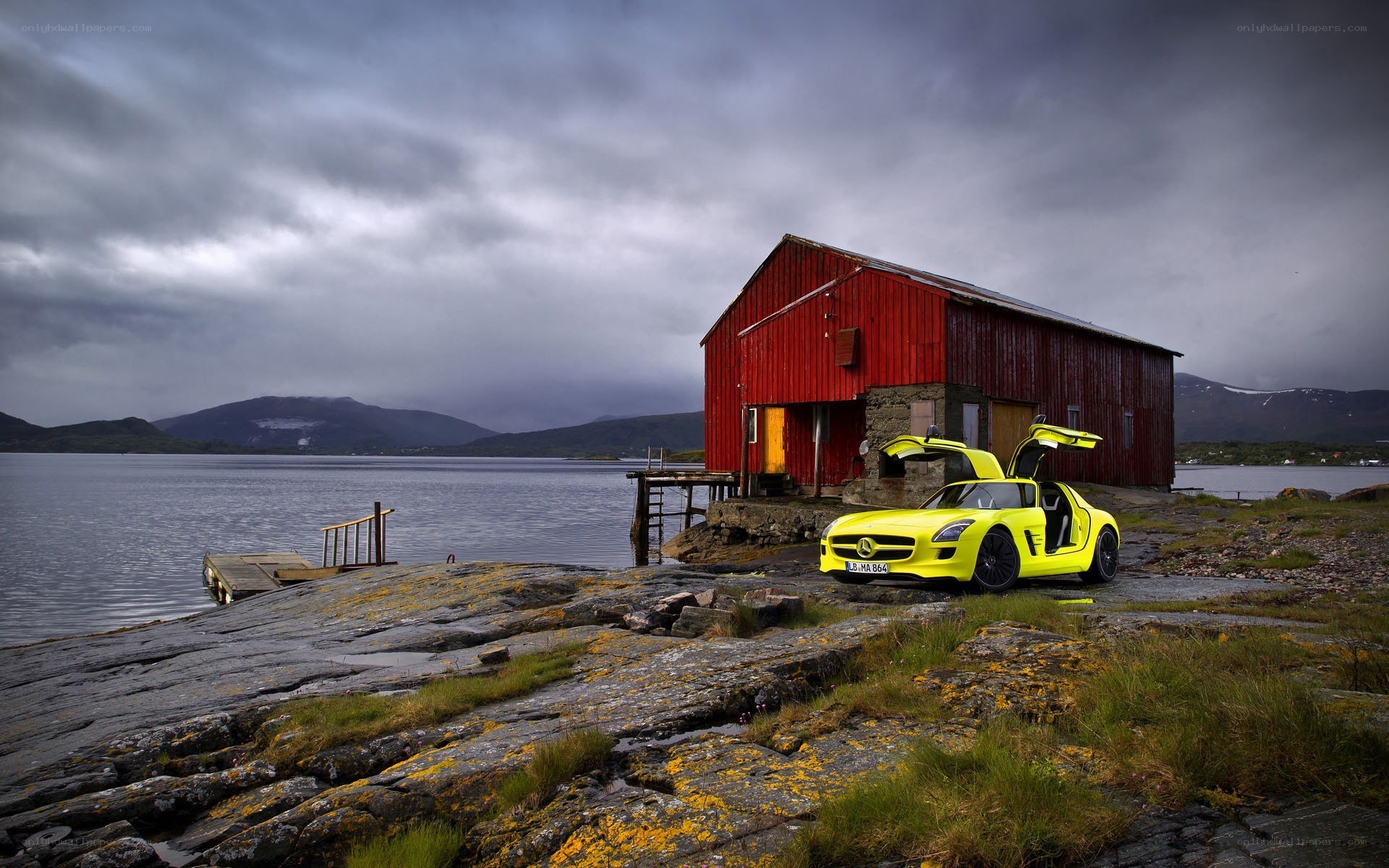 Yellow car by red barn