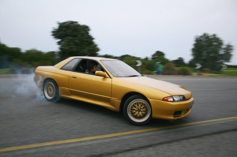 yellow car drifting on road