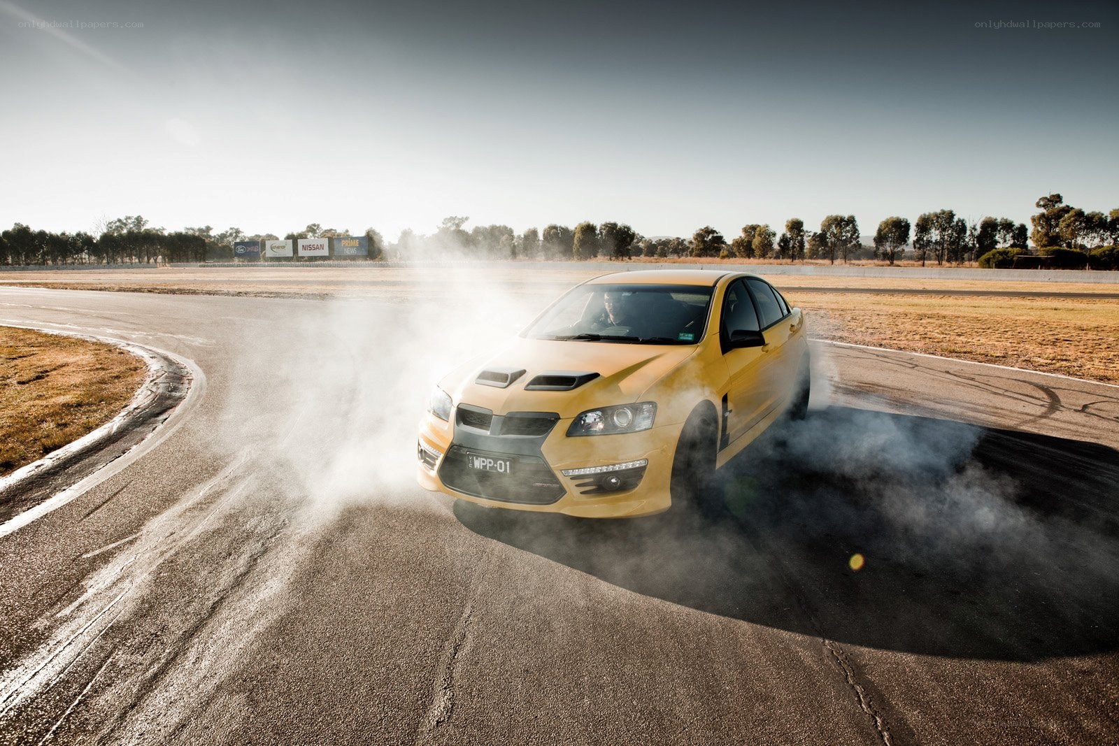Yellow car drifting on track