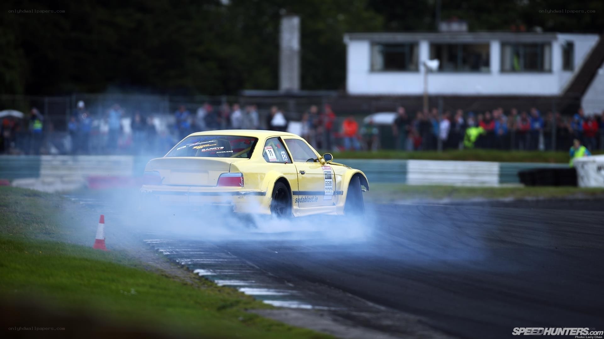 Yellow car drifting on track