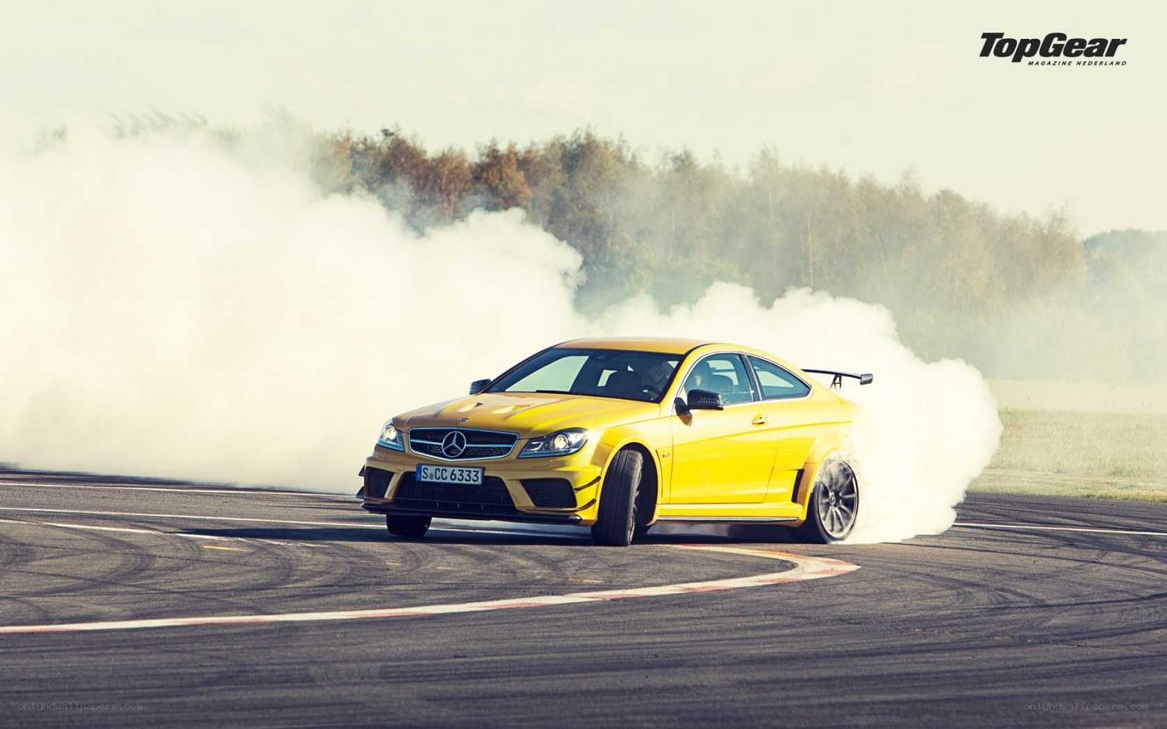 Yellow car drifting on track