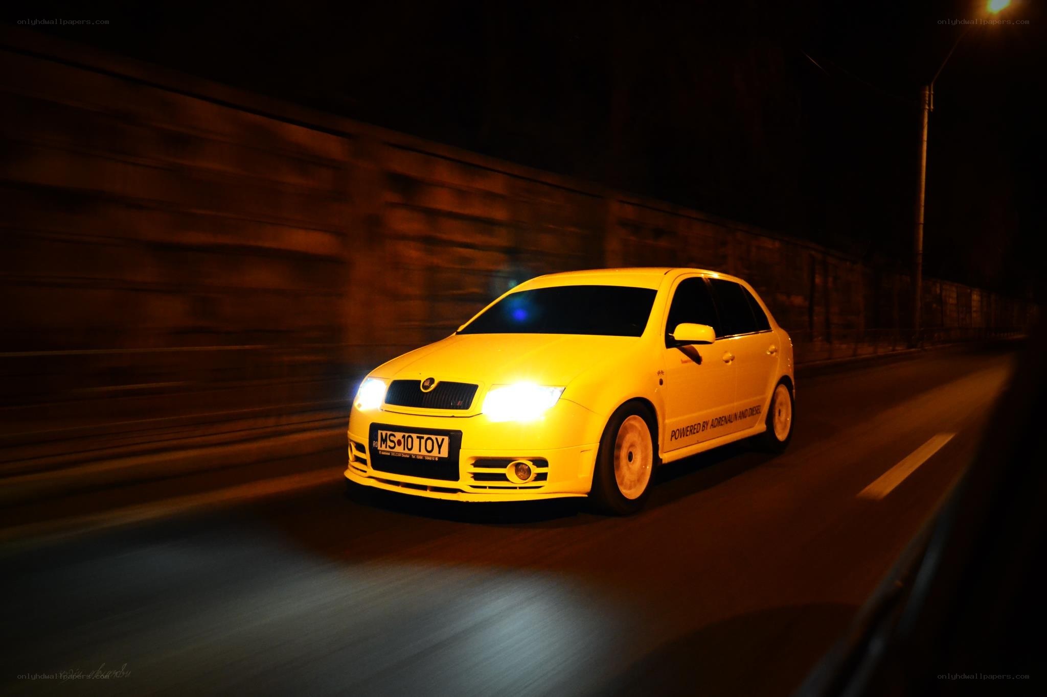 Yellow car driving at night