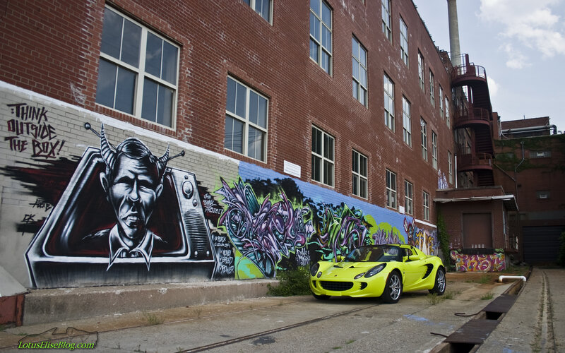 Yellow car in alley with graffiti