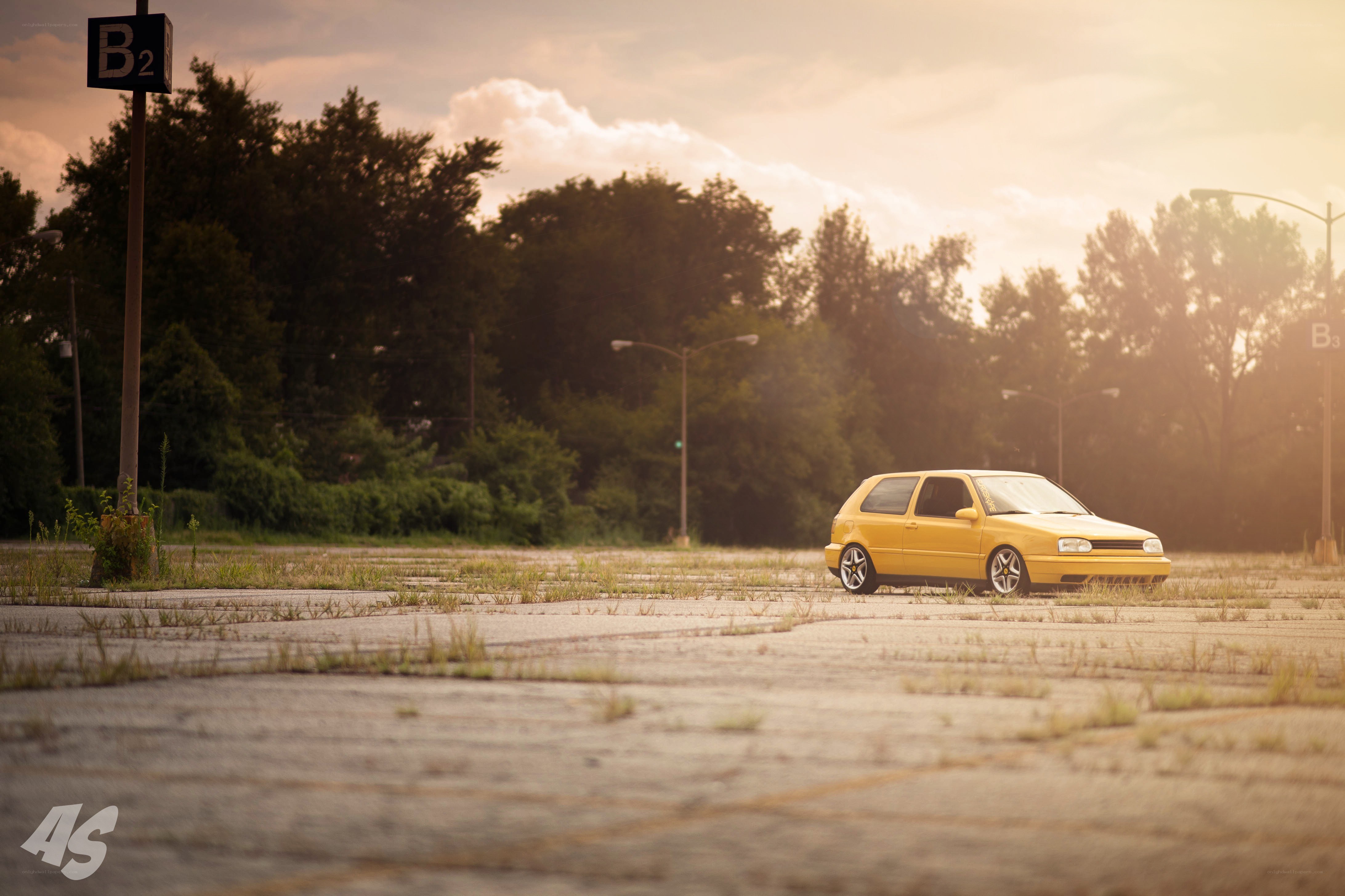 Yellow car in empty lot