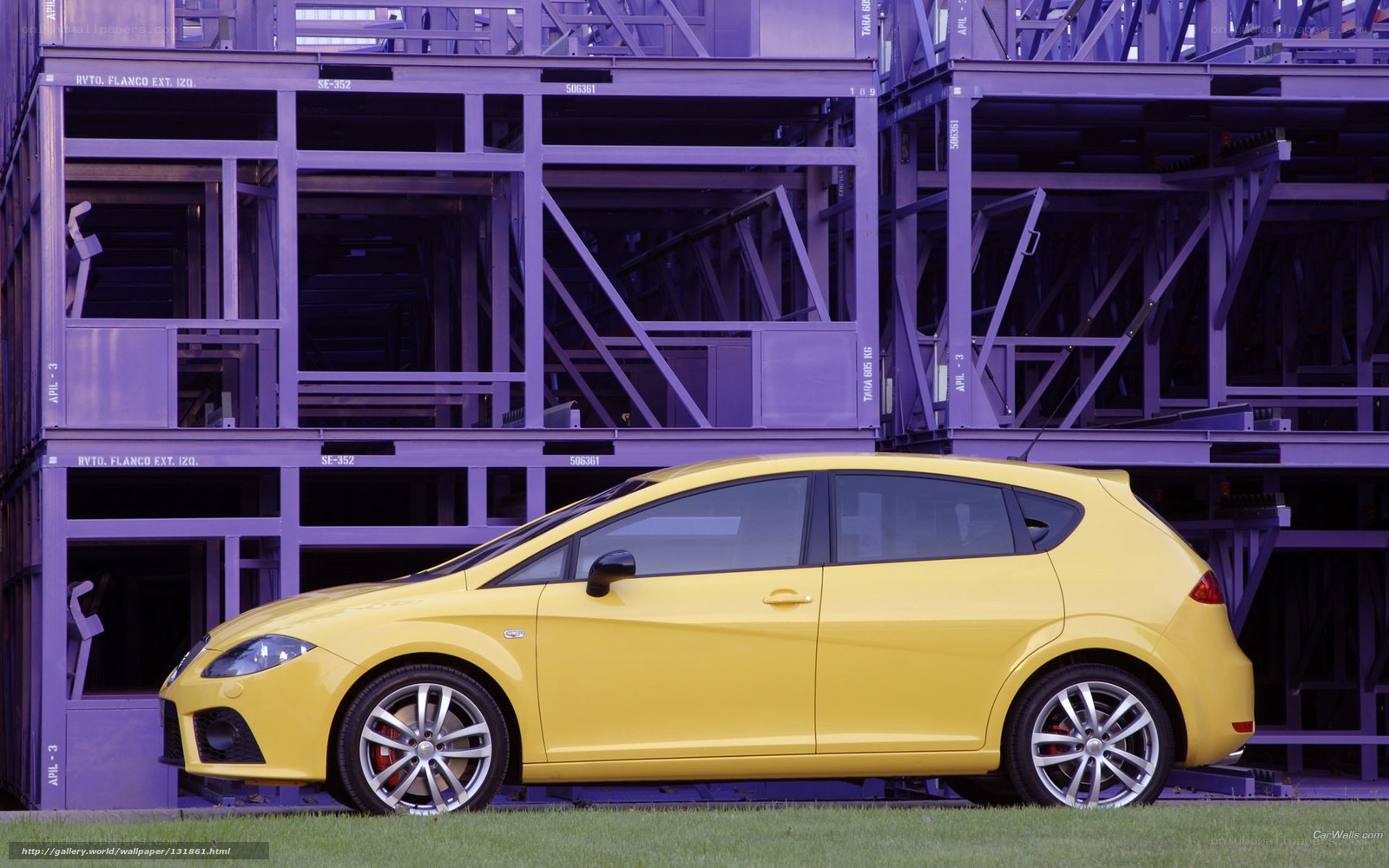 yellow car in front of purple structure