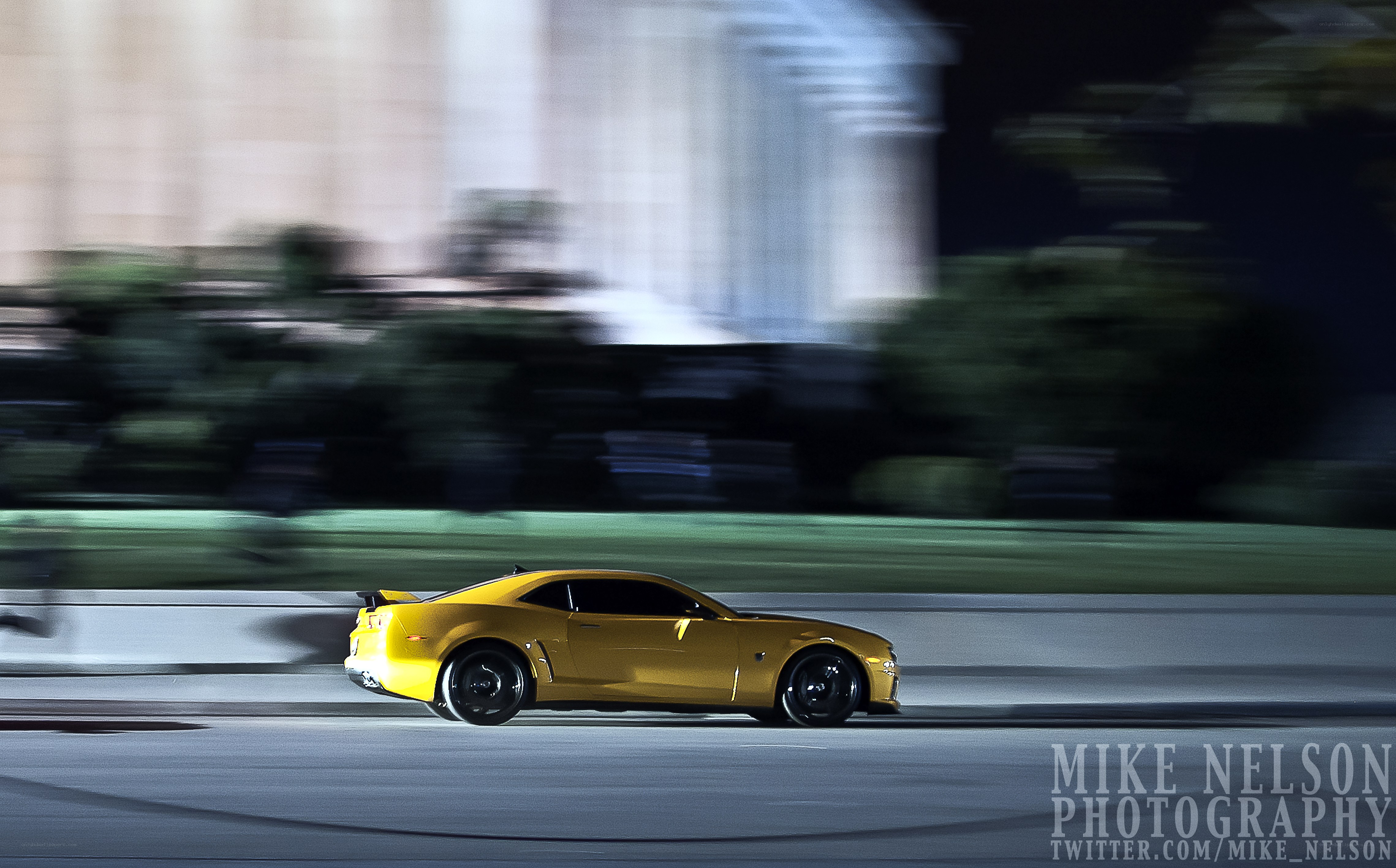 Yellow car in motion at night