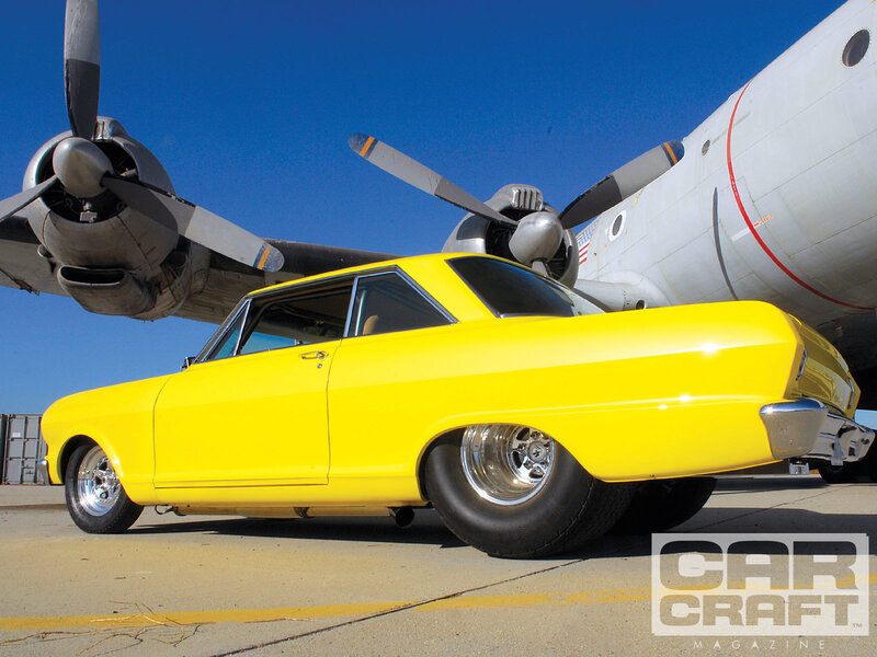 Yellow car near airplane