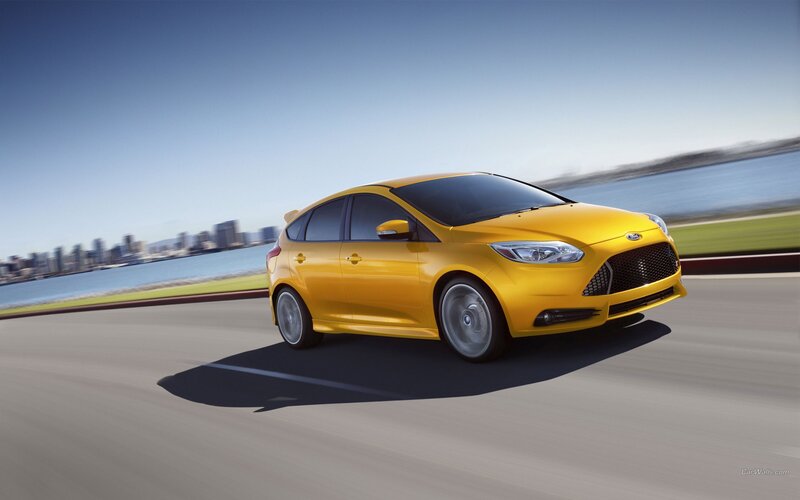 yellow car on a coastal road