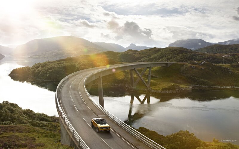 Yellow car on a scenic bridge