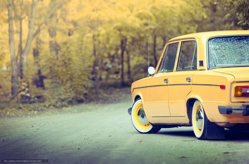 Yellow car on autumn road