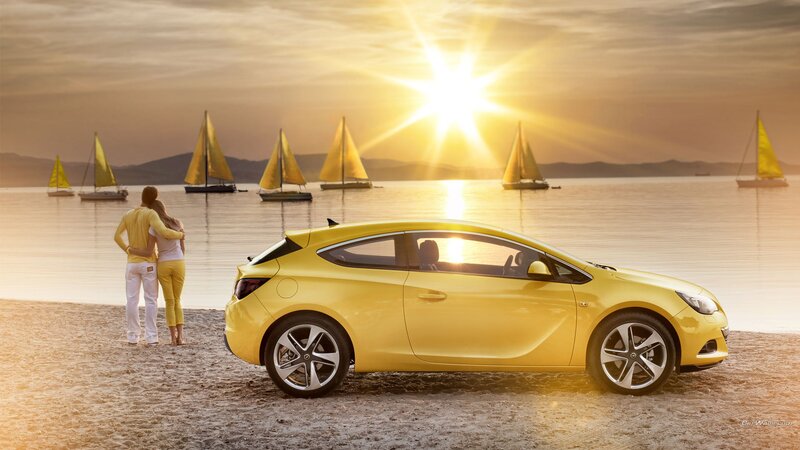 Yellow car on beach at sunset