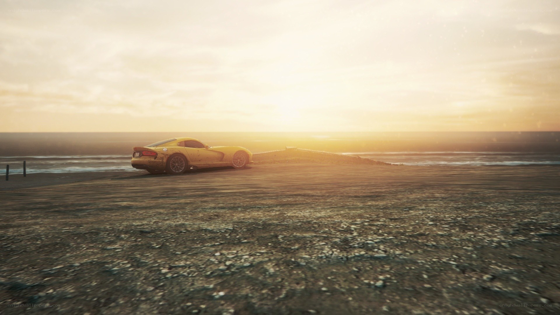 Yellow car on beach at sunset