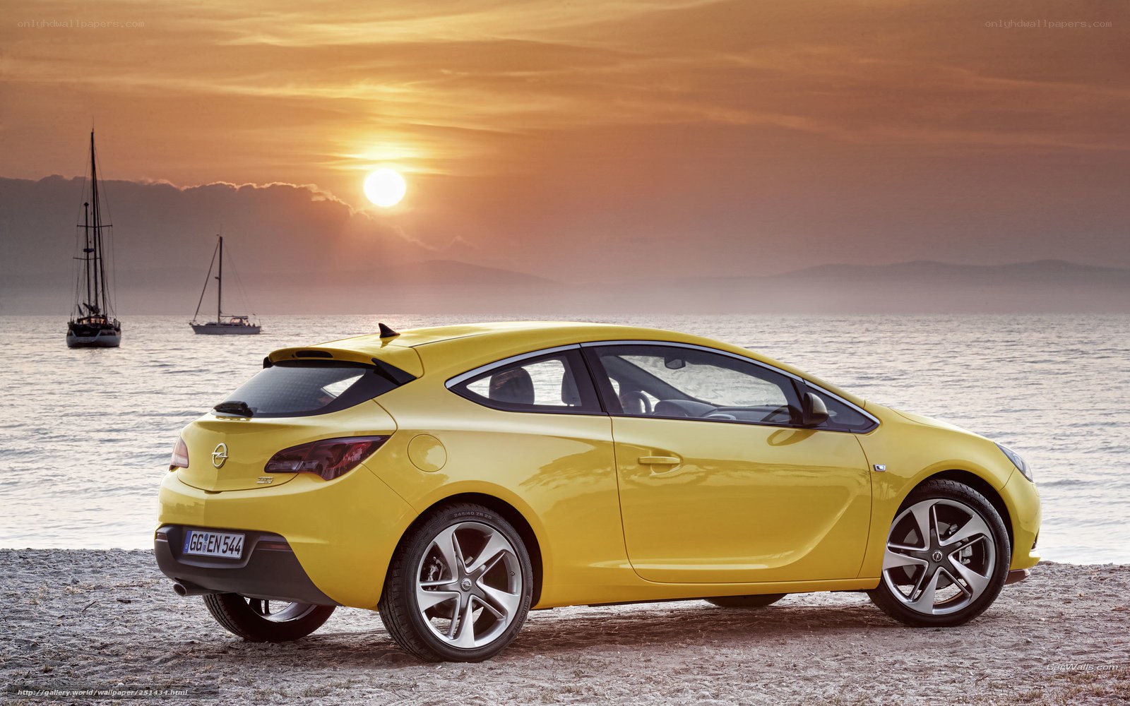 Yellow car on beach at sunset