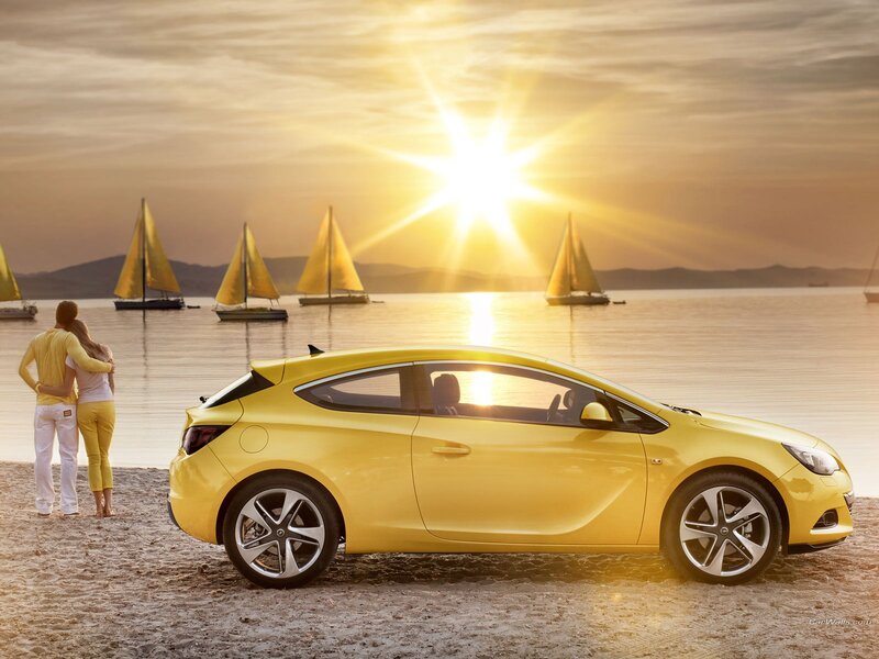 Yellow car on beach at sunset