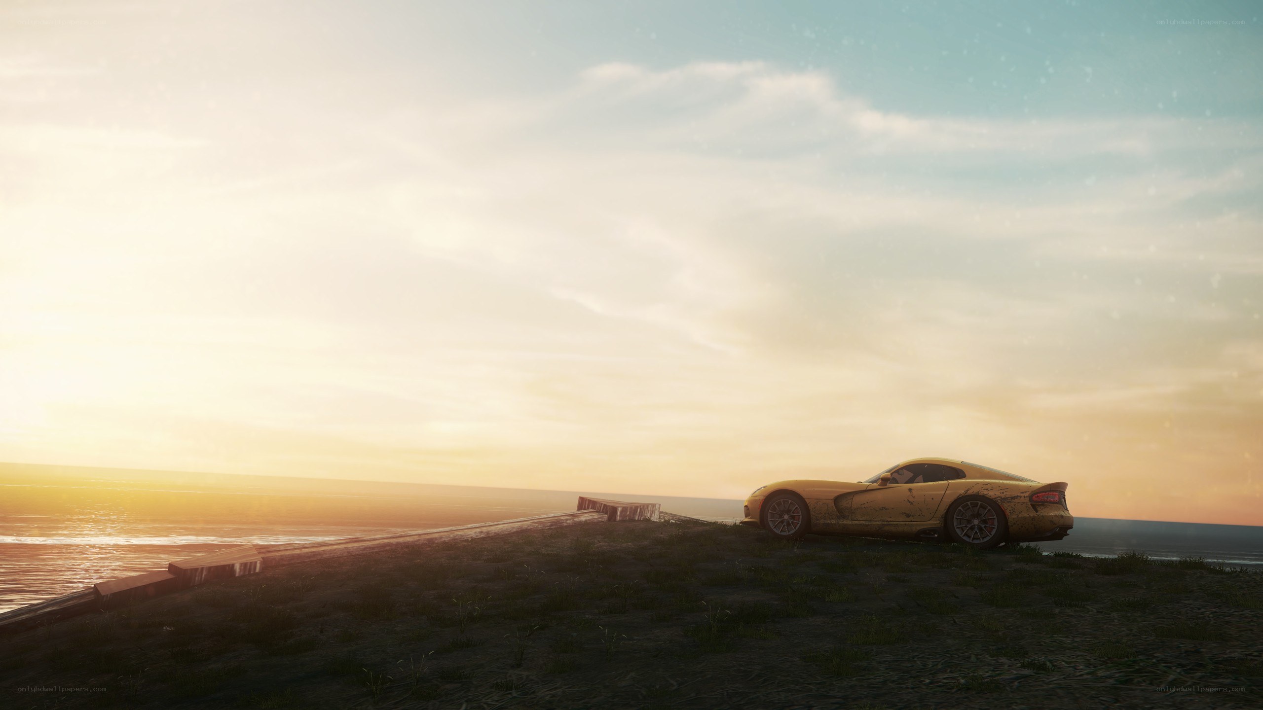 Yellow car on cliff at sunset
