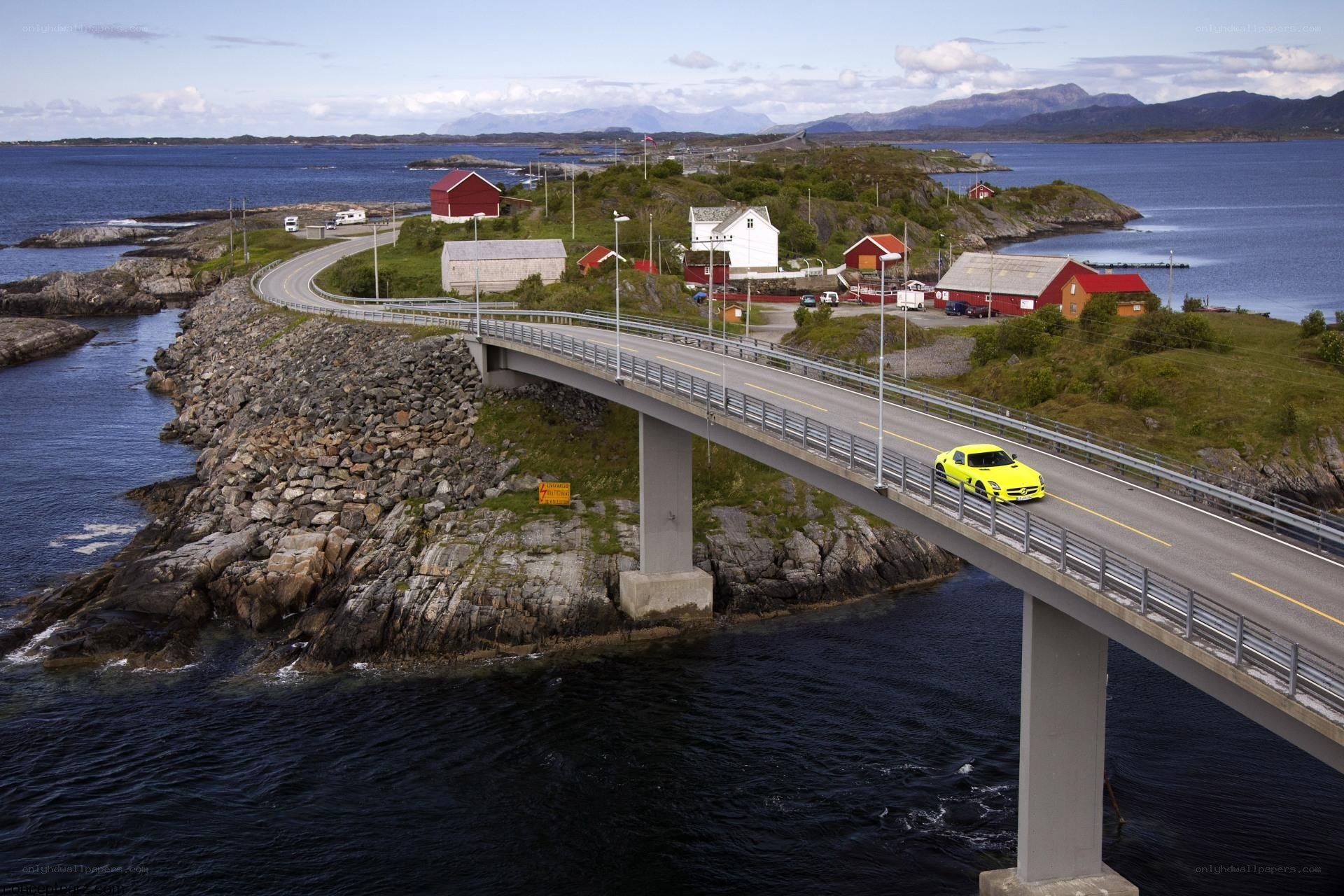 Yellow car on coastal bridge
