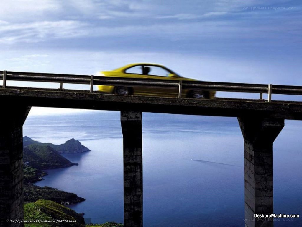 Yellow car on coastal bridge