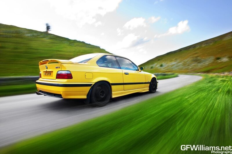 yellow car on country road