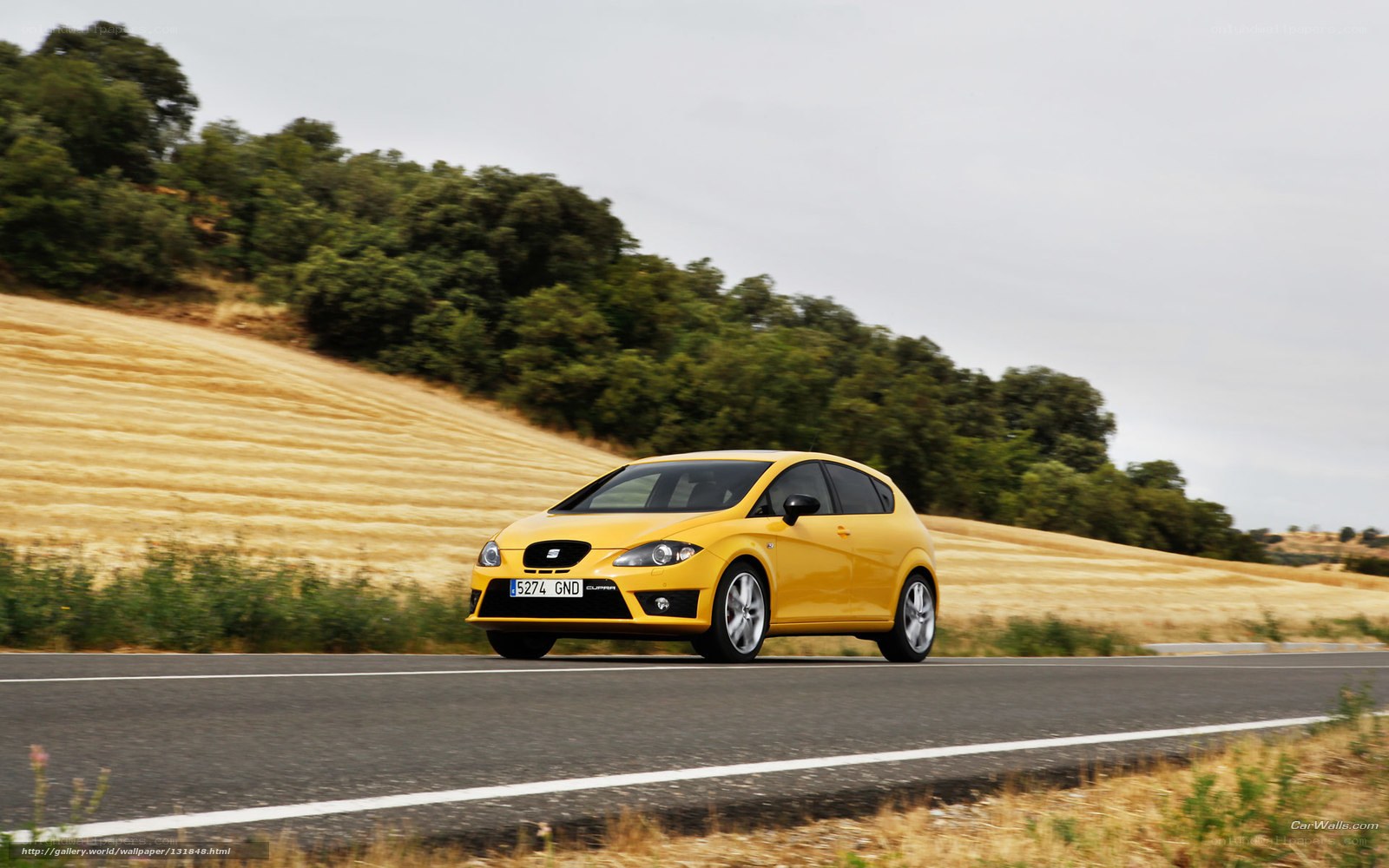 yellow car on country road