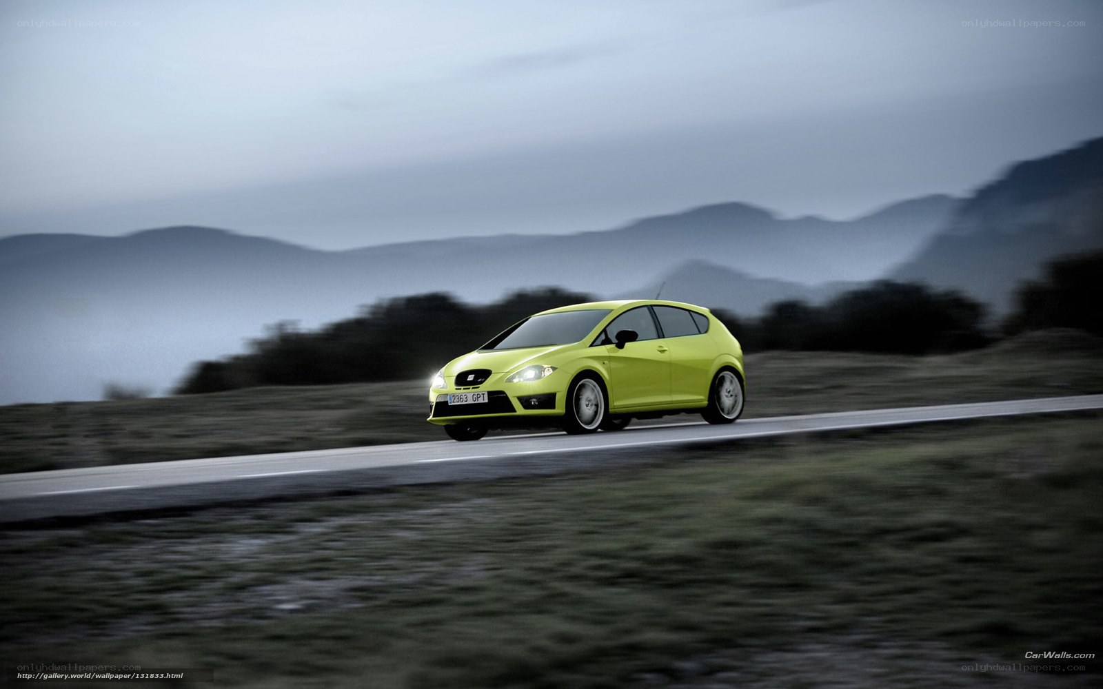 yellow car on mountain road