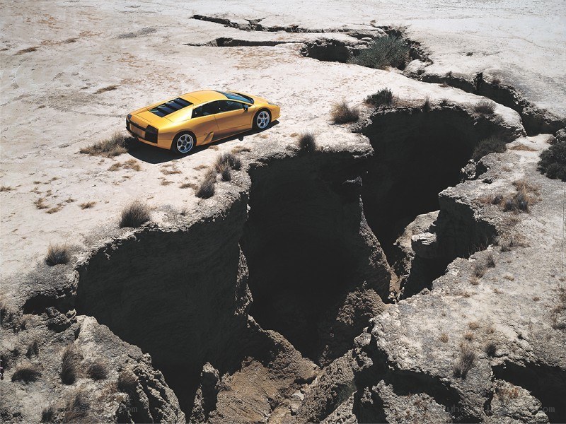 Yellow car on rocky cliff