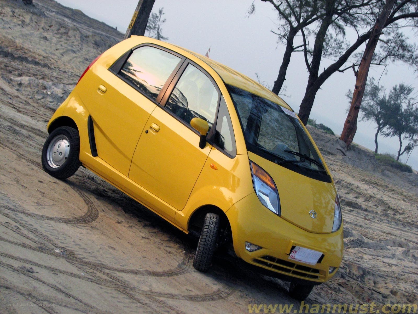 Yellow car on sandy slope