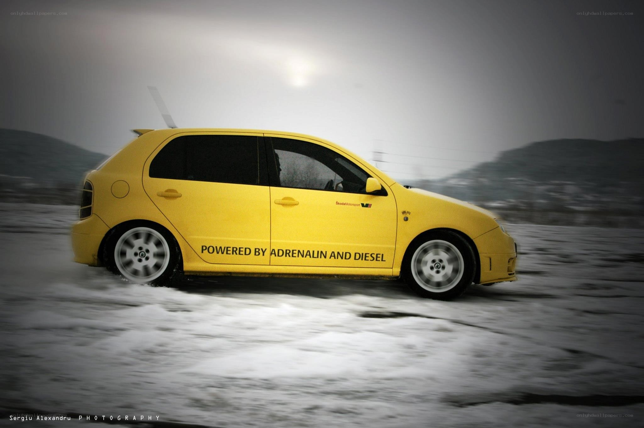 Yellow car on snowy road