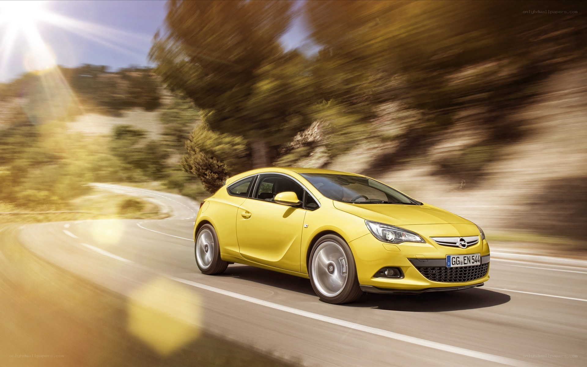 yellow car on winding road