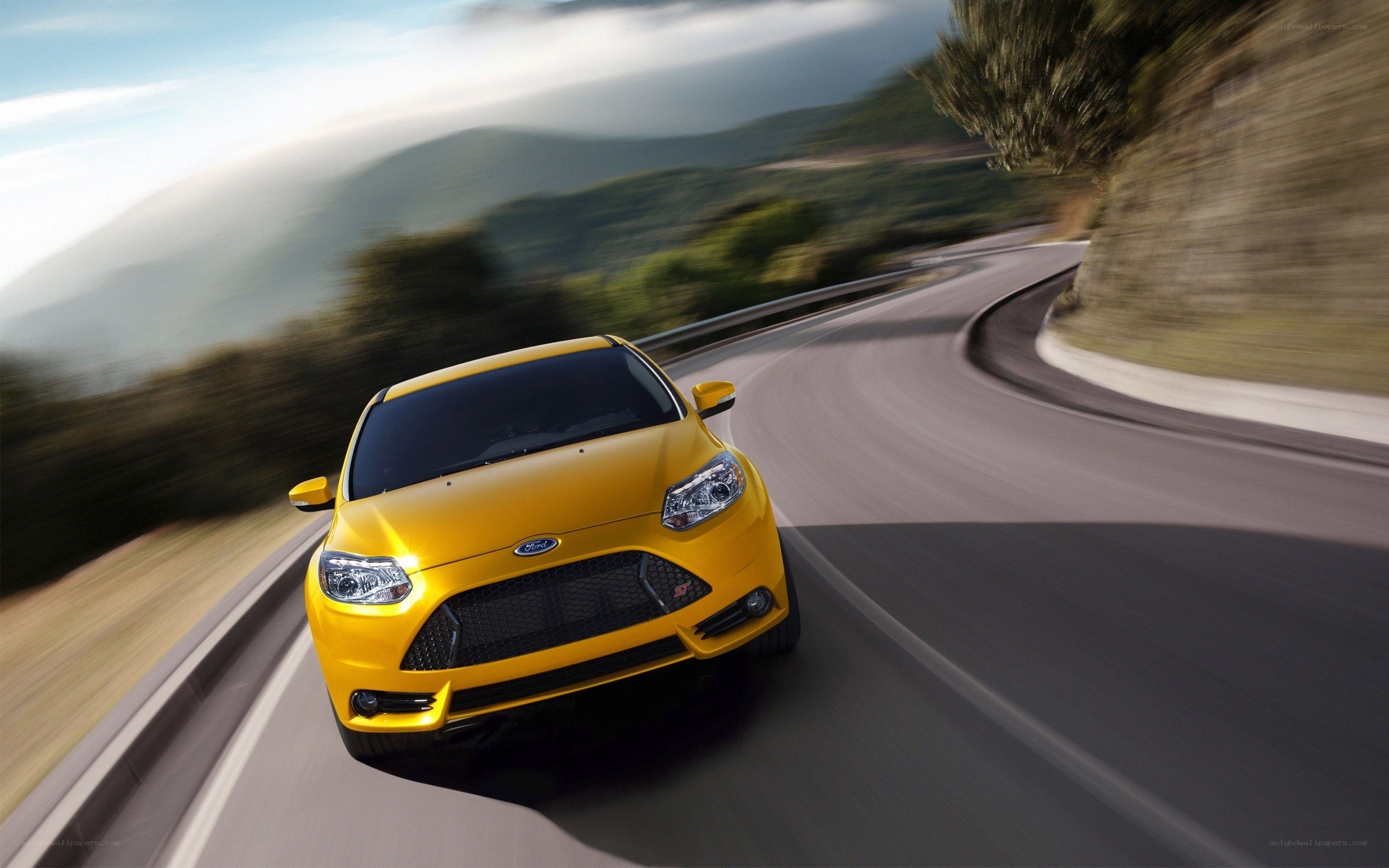 yellow car on winding road