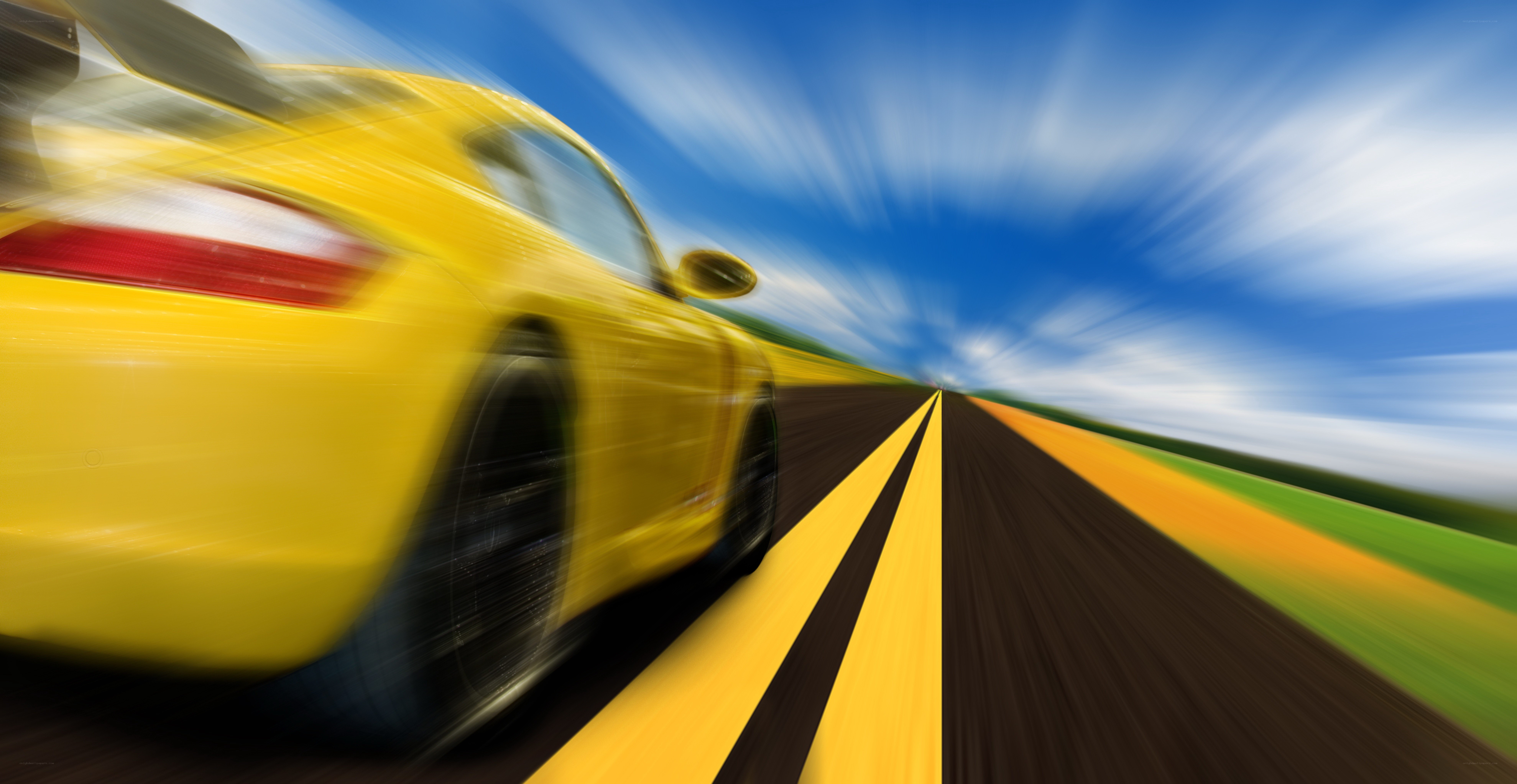 Yellow car speeding on road