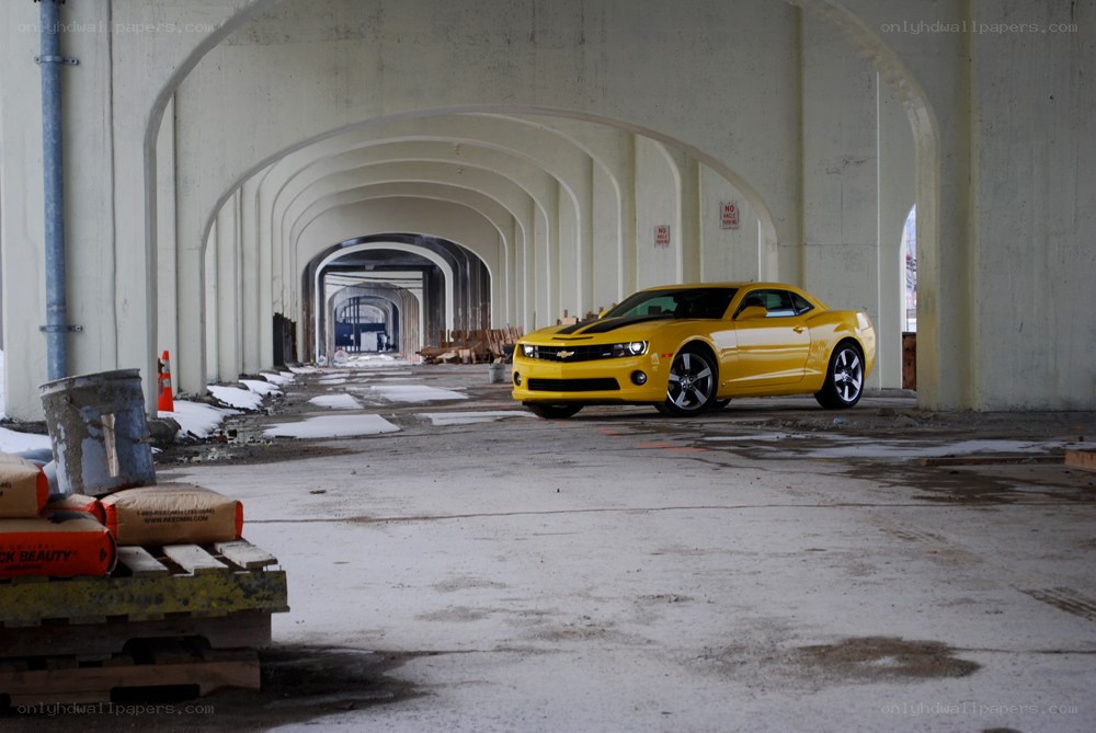 Yellow car under concrete tunnel
