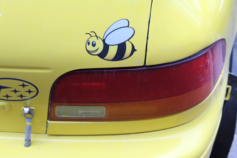 yellow car with bee sticker