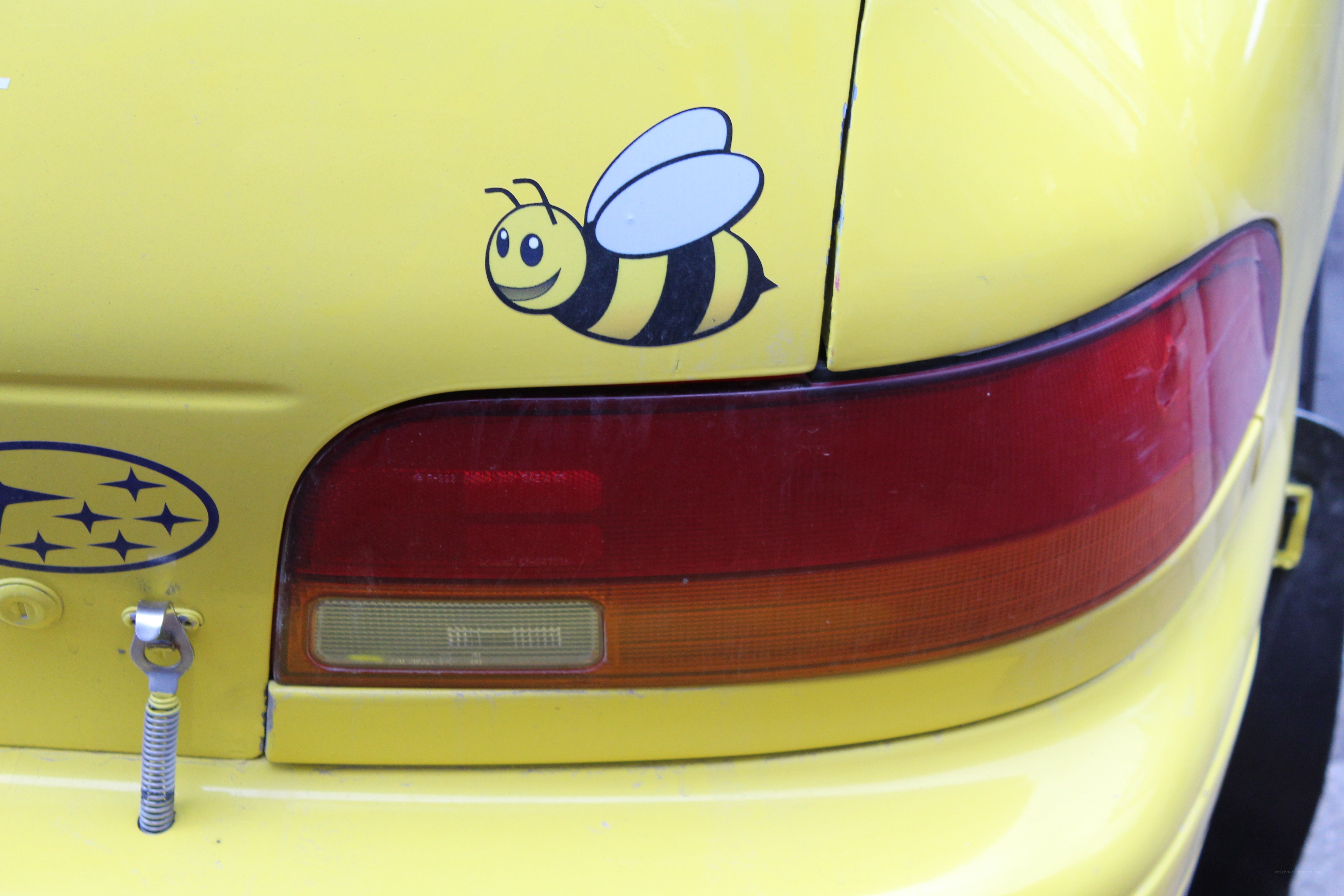 yellow car with bee sticker