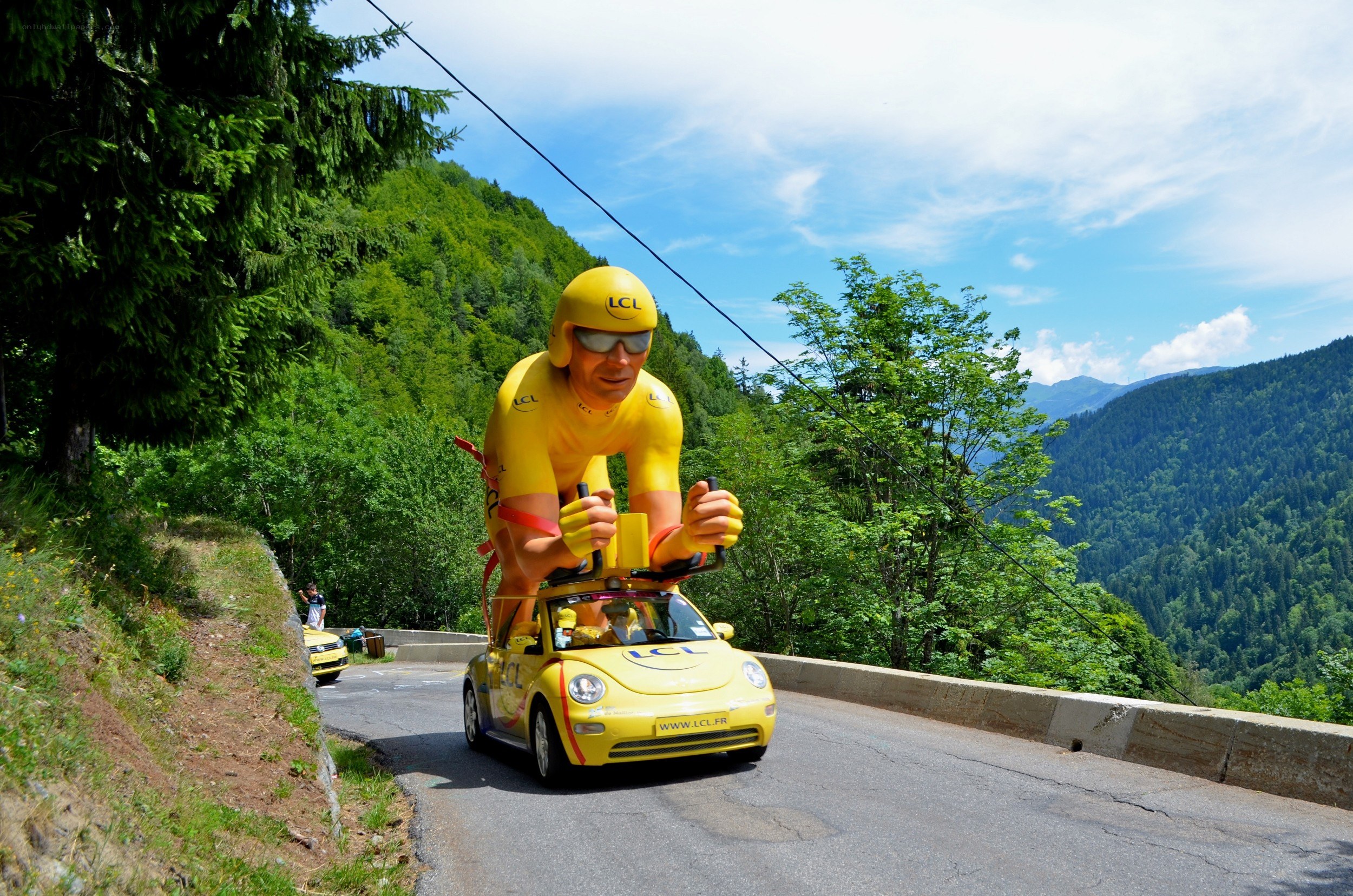 Yellow car with cyclist figure