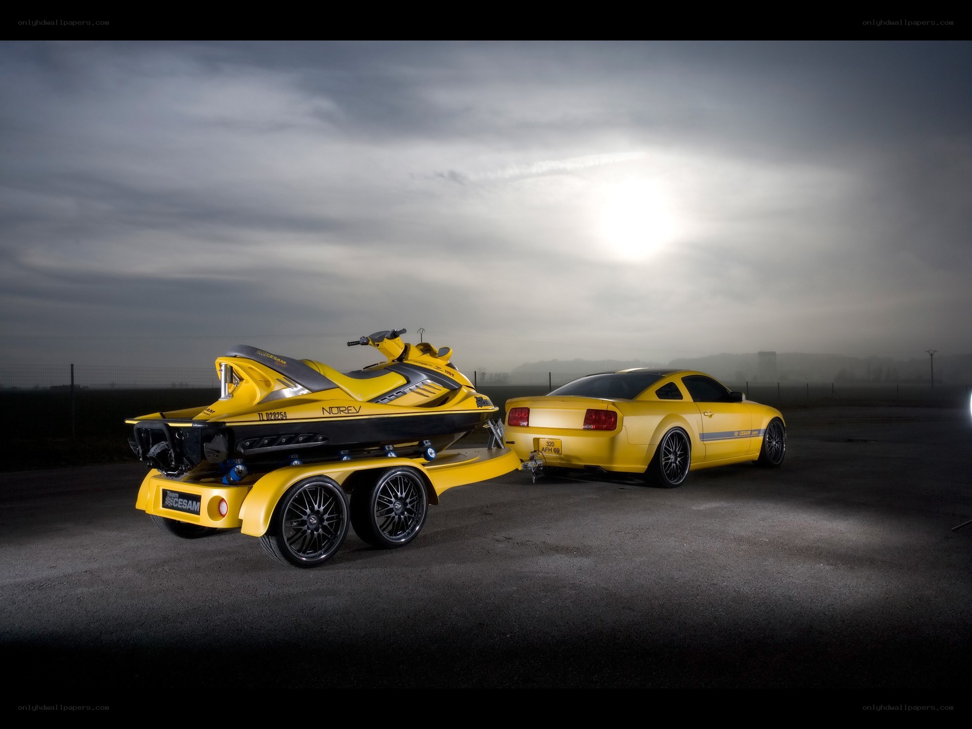 Yellow car with jet ski trailer