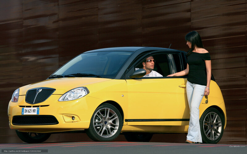 Yellow car with man and woman