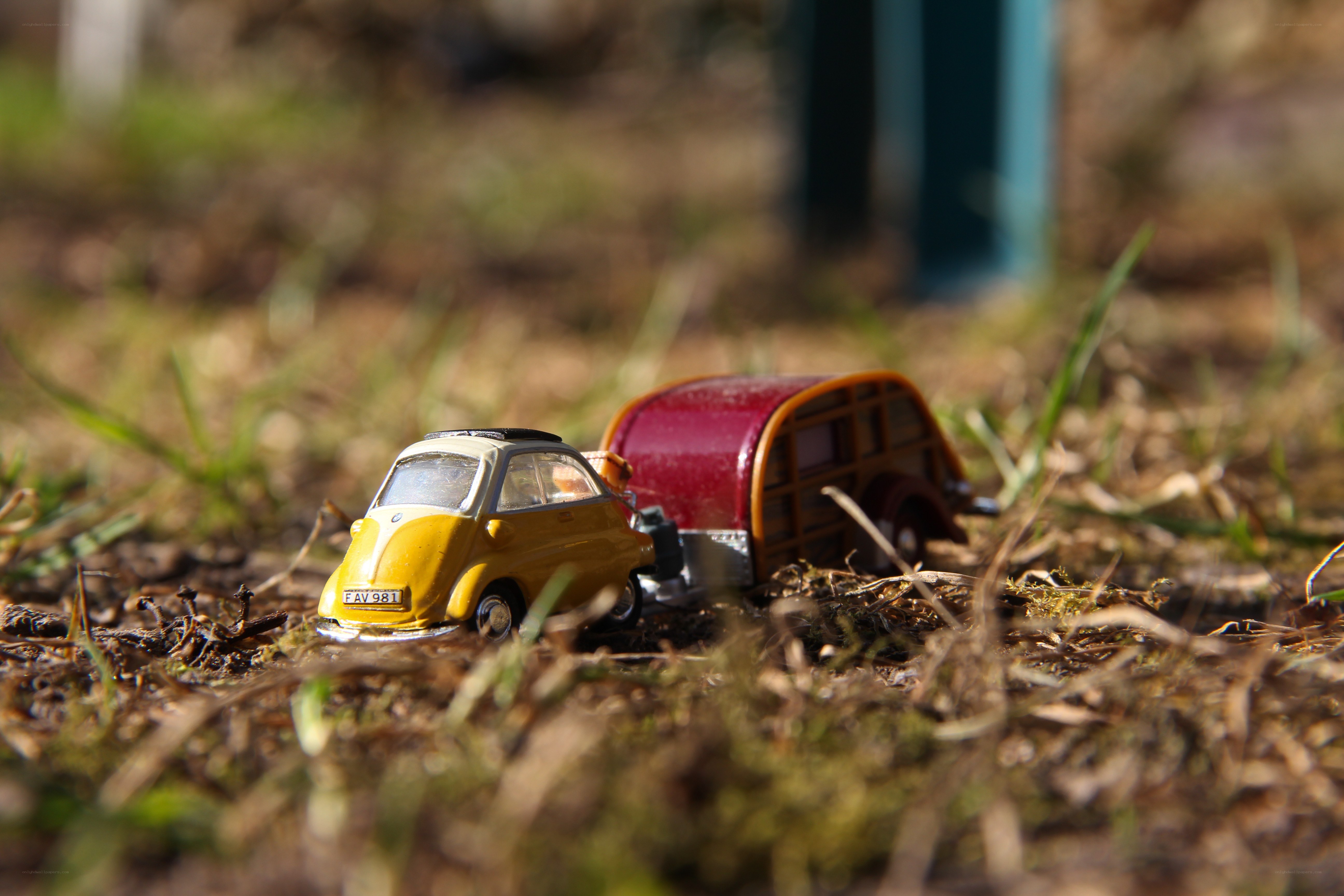Yellow car with trailer in grass
