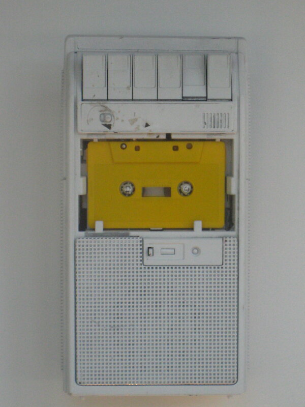 yellow cassette tape in player