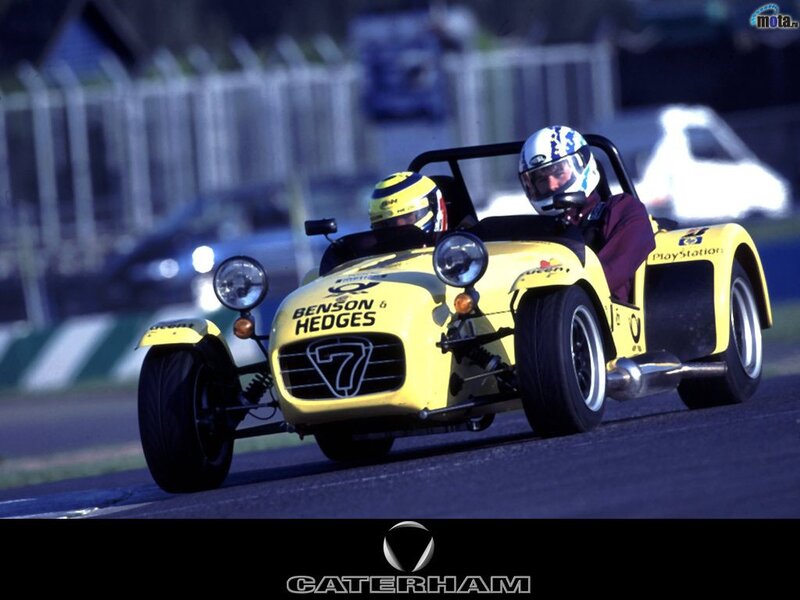 Yellow Caterham race car on track
