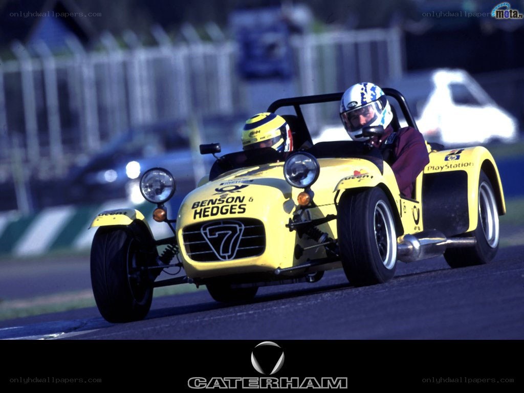 Yellow Caterham race car on track