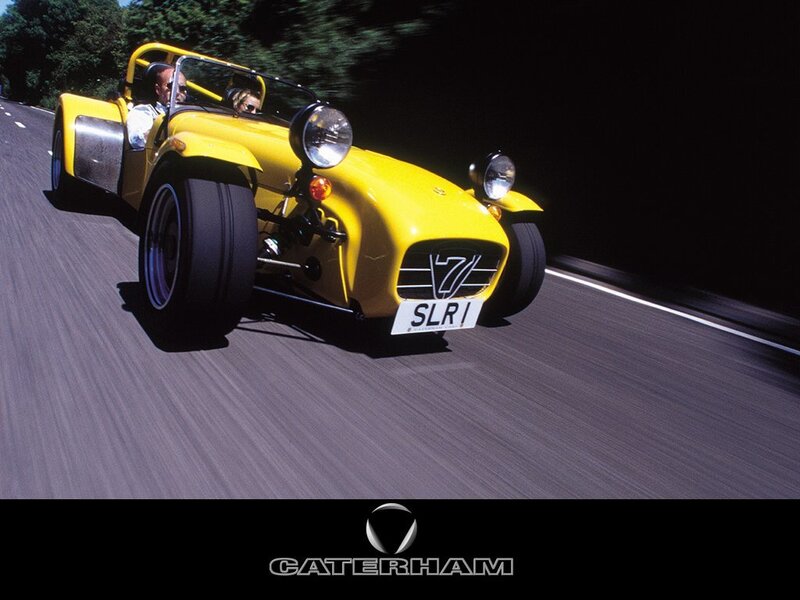 Yellow Caterham sports car on road