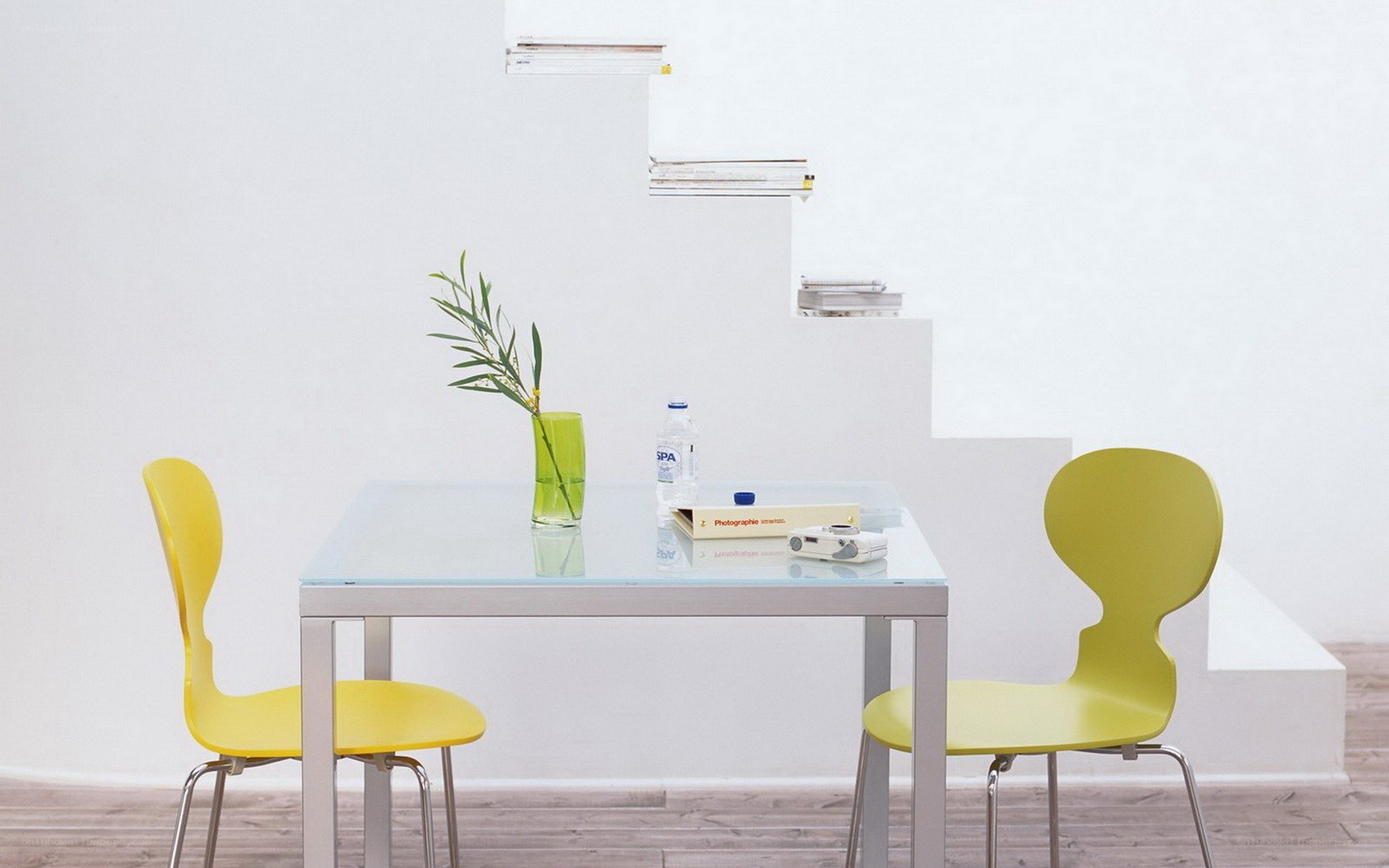 Yellow chairs at a glass table