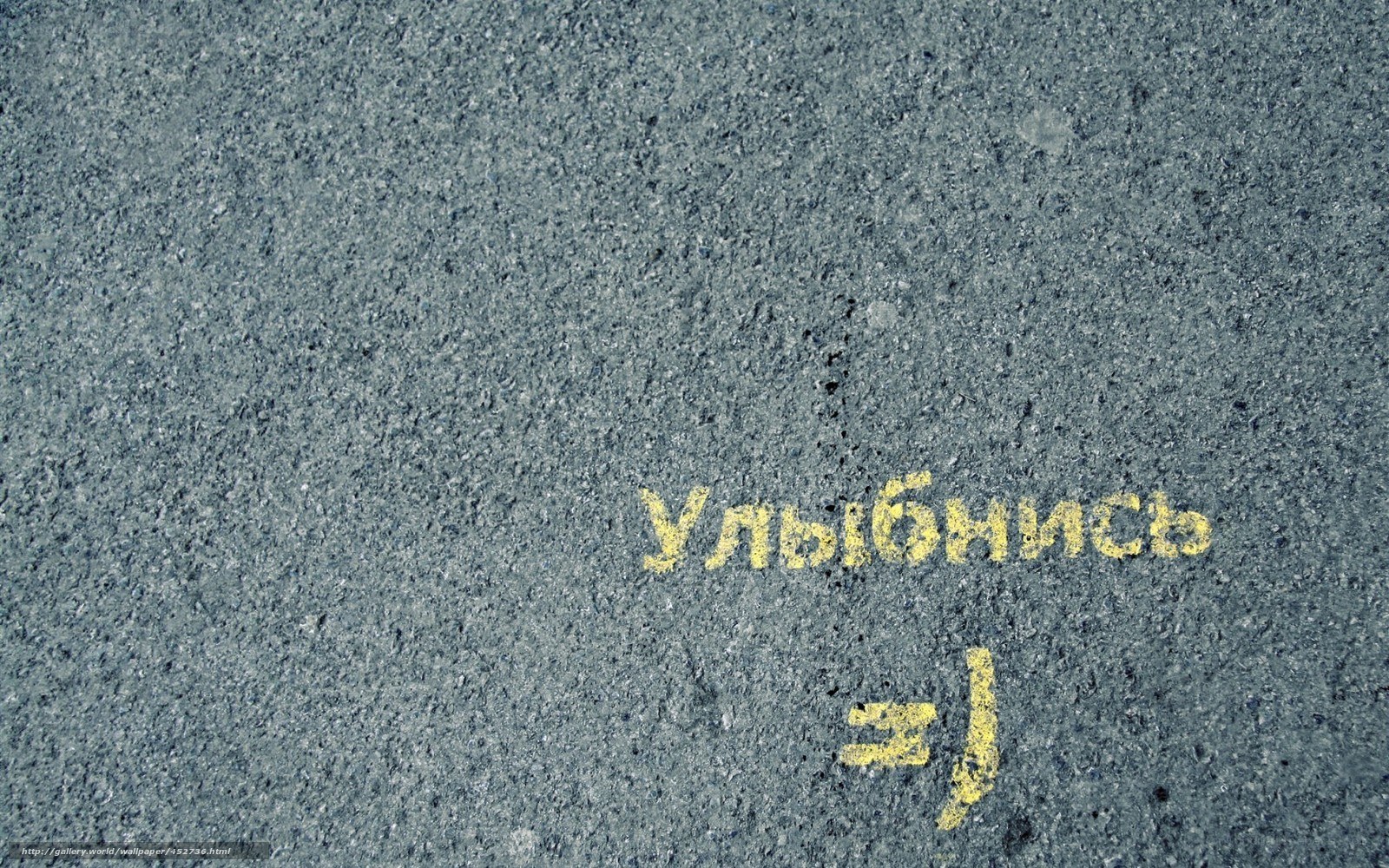 Yellow chalk writing on pavement