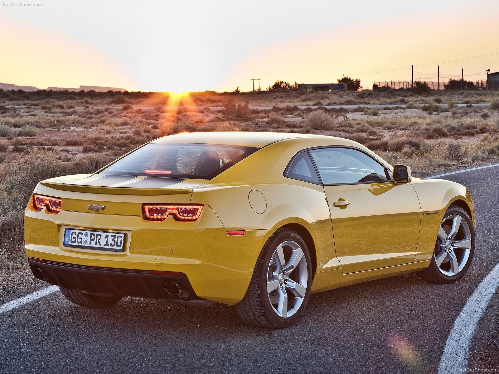 yellow chevrolet camaro at sunset