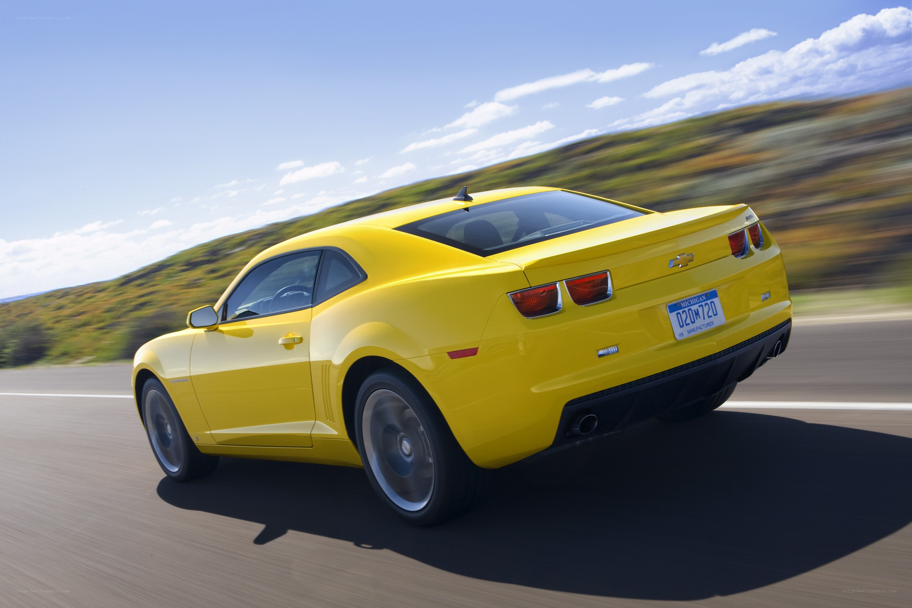 yellow chevrolet camaro driving
