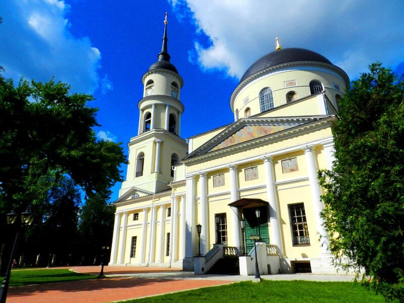 yellow church with dome and steeple