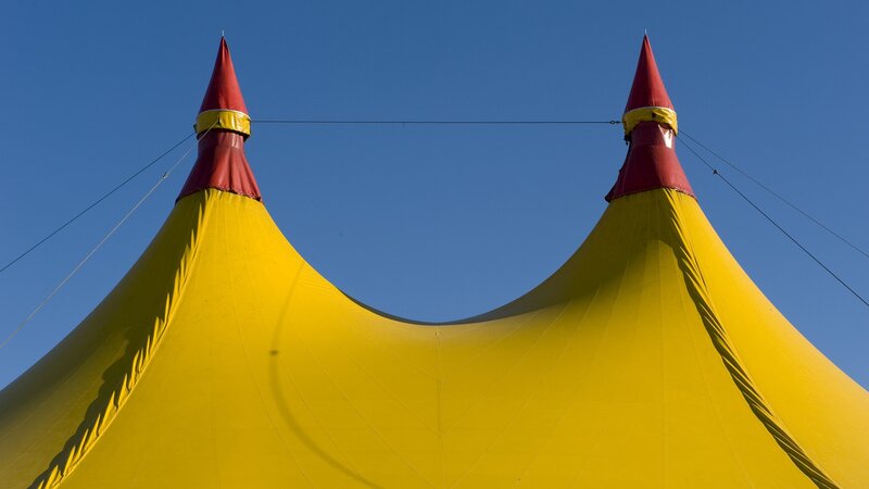 Yellow circus tent with red peaks
