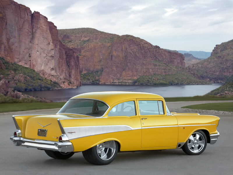 Yellow classic car by a lake