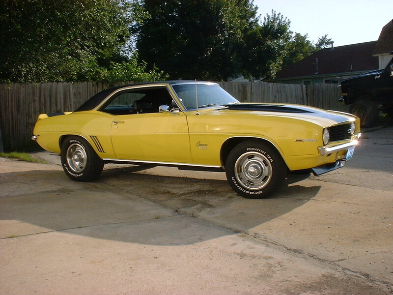 Yellow Classic Car — Calm, Afternoon, Photograph, Wooden Fence